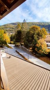 a wooden deck with a view of a river at Appartamenti Vacanze Lagolo in Lagolo di Calavino