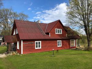 a red house with a red roof at Sokka Holiday Center & Glamping in Otepää