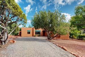 a house with trees in front of a driveway at The Artist's Hideaway in Sedona