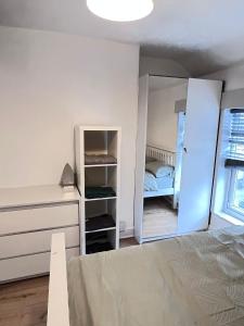 a bedroom with a bed and a mirror at 36 park road house in Nottingham