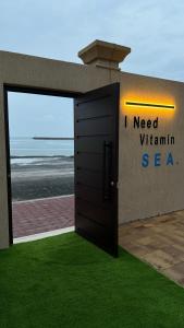 a door to a building with the ocean behind it at sea breeze RAK in Ras al Khaimah