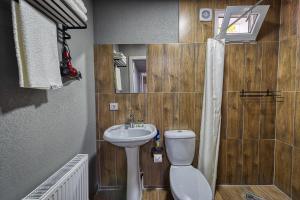 a small bathroom with a sink and a toilet at ИксаОтель in Shymkent