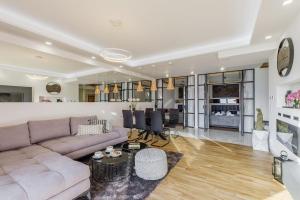 a living room with a couch and a table at MountainBase - Widokowy 1 in Kościelisko