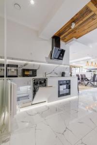 a kitchen with white appliances in a room at MountainBase - Widokowy 1 in Kościelisko