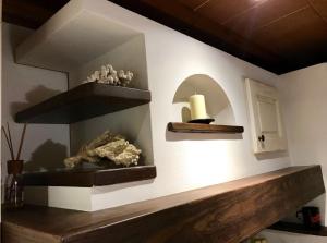 a room with a shelf andartifacts on a wall at My Tuscany House - C1 in Montelupo Fiorentino +25 photos