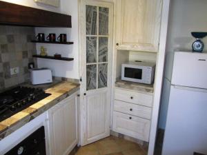 a kitchen with a white refrigerator and a microwave at My Tuscany House - C1 in Montelupo Fiorentino