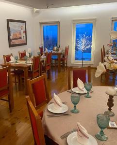 a dining room with tables and chairs with a sparkler in the window at Varanda Do Alentejo in Marvão