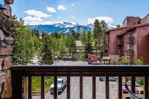 a balcony with a view of a parking lot and mountains at Pine Ridge 05F in Breckenridge