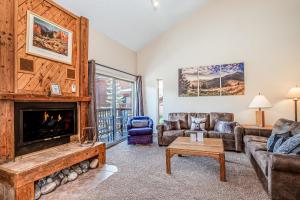 a living room with a fireplace and couches at Pine Ridge 05F in Breckenridge