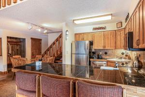 a kitchen with wooden cabinets and a large counter top at Pine Ridge 05F in Breckenridge