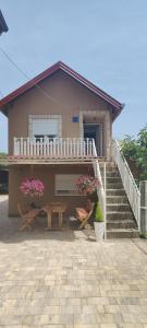 a house with stairs and a table and flowers at Budget Friendly in Požega