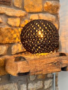 a candle on a piece of wood with a stone wall at Quite Simply French in Lancaster