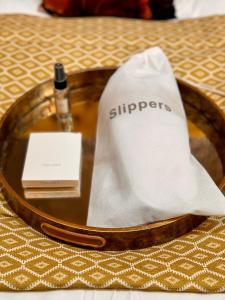 a table with a tray with a bottle and a napkin at Quite Simply French in Lancaster