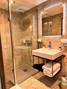 a bathroom with a sink and a shower at Quite Simply French in Lancaster