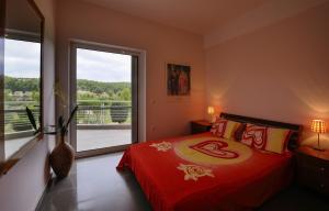a bedroom with a bed and a large window at Olivos Villa Sani in Sani Beach +51 photos