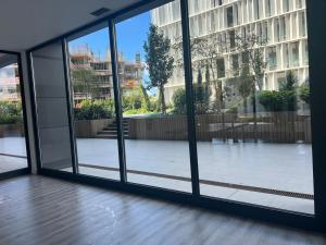 an empty room with large windows in a building at S.Soares T3 Expo Sul in Lisbon