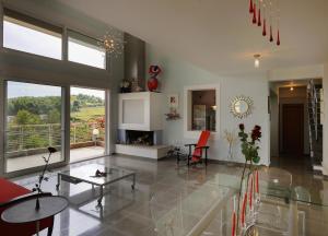 a living room with a glass table and a fireplace at Olivos Villa Sani in Sani Beach