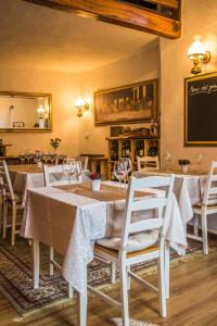 a dining room with a table and chairs and a chalkboard at Relais San Filippo in Sogaglia in Mulazzo
