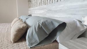 a bed with two pillows on top of it at Hotel Boutique Aroma de Mar in Chiclana de la Frontera