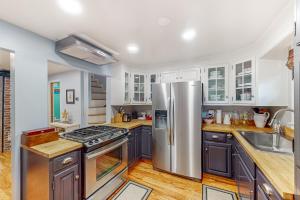a kitchen with stainless steel appliances and wooden floors at Skyline Sanctuary in Annapolis