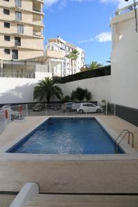 a swimming pool in front of a building at Apartamento el Cid in Calpe