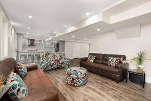 a living room with couches and chairs and a kitchen at Walk-out Basement with Private Entrance in Brampton