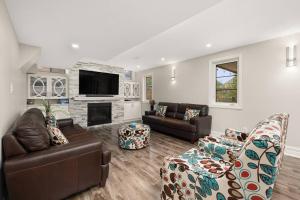 a living room with leather furniture and a fireplace at Walk-out Basement with Private Entrance in Brampton