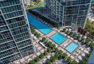 an aerial view of a building with two pools at LUXURY 1BR CONDO W Icon Brickell-FREESPA in Miami
