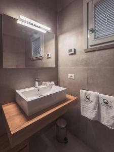 a bathroom with a white sink and a mirror at Agriturismo Querceto in Frazione Mocaiana