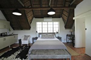 a bedroom with a large bed and a large window at Mountain View Swellendam in Swellendam