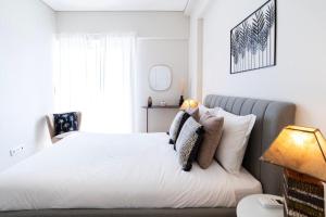 a bedroom with a bed with white sheets and pillows at NEW - Luxury & bright apartment Lisbon in Lisbon