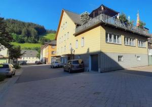 a yellow building with a balcony on top of it at Gemütliche Wohnung 80qm - viele Ausflugsziele in Vöhrenbach