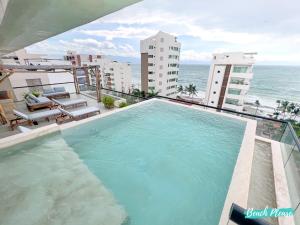 a swimming pool on top of a building with the ocean at Arenka - 2BR w Private Pool & Sunset Rooftop in Bucerías