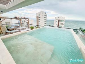 a large swimming pool on top of a building at Arenka - 2BR w Private Pool & Sunset Rooftop in Bucerías +30 photos