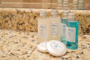 three bottles of liquid sitting on a granite counter top at Hotel Gergana - Ultra All Inclusive in Albena