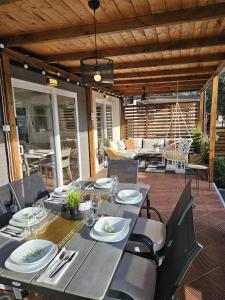 a dining table and chairs on a patio at Bajki Mobile home in Biograd na Moru