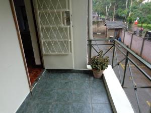 a balcony with a door and a potted plant at Amani guest house in Nairobi