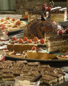 a table topped with different types of cakes and desserts at Hotel Gergana - Ultra All Inclusive in Albena