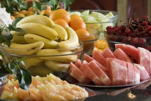 a bunch of fruit on a table with bowls of fruits at Hotel Gergana - Ultra All Inclusive in Albena