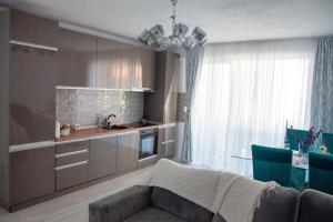 a kitchen with a couch and a table in a room at Noa Residence in Alba Iulia