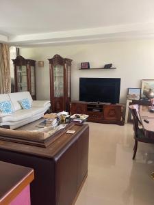 a living room with a couch and a flat screen tv at Fenix Villa in Noicattaro