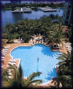 an overhead view of a large swimming pool with palm trees at Pet-Friendly Aventura Pool, Beach, Golf, Gym in Aventura