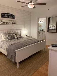 a bedroom with a large bed with a ceiling fan at Pet-Friendly Aventura Pool, Beach, Golf, Gym in Aventura