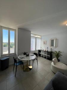 a large living room with a table and chairs at T2 la dolce vita panissière in Panissières