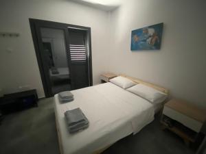 a bedroom with a white bed and a mirror at Green Bay Area Apartment in Protaras
