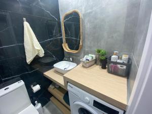 a bathroom with a sink and a toilet and a mirror at Green Bay Area Apartment in Protaras +12 photos