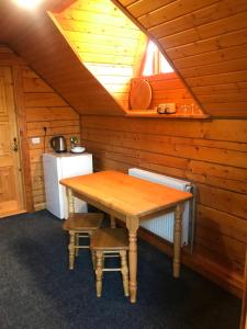 a kitchen with a wooden table in a cabin at Trembita in Yablunytsya
