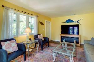 a living room with a couch and a tv at West Palm Beach Home with Fenced-In Yard and Deck! in West Palm Beach