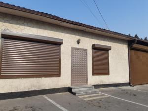 a building with two garage doors and a window at Lunis in Geghanist