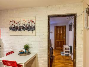 a dining room with a table and red chairs at Little house in Kaunas